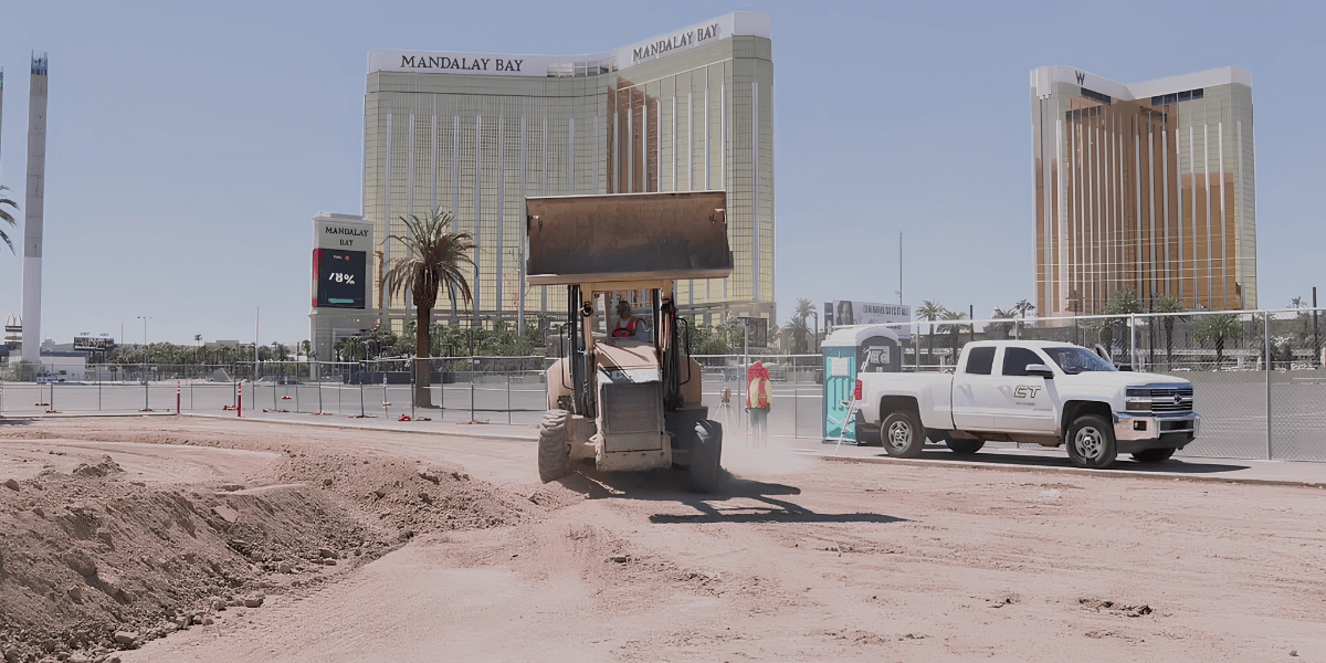 Construction work in progress with a bulldozer and Mandalay Bay in the background